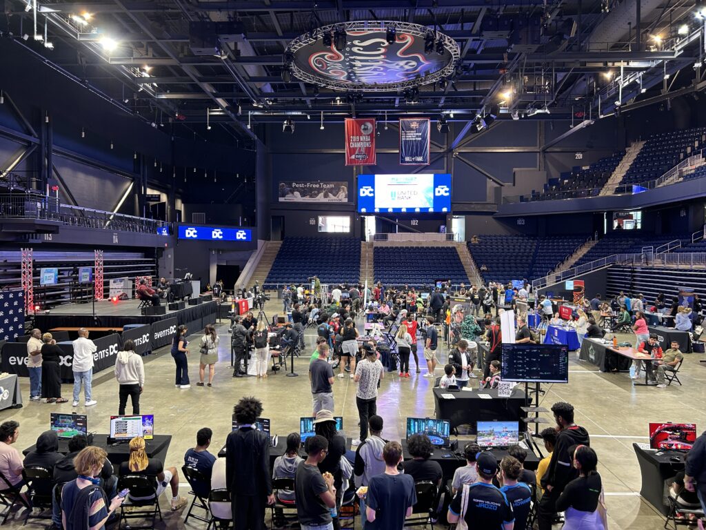 Photograph of the event, with esports players in the foreground